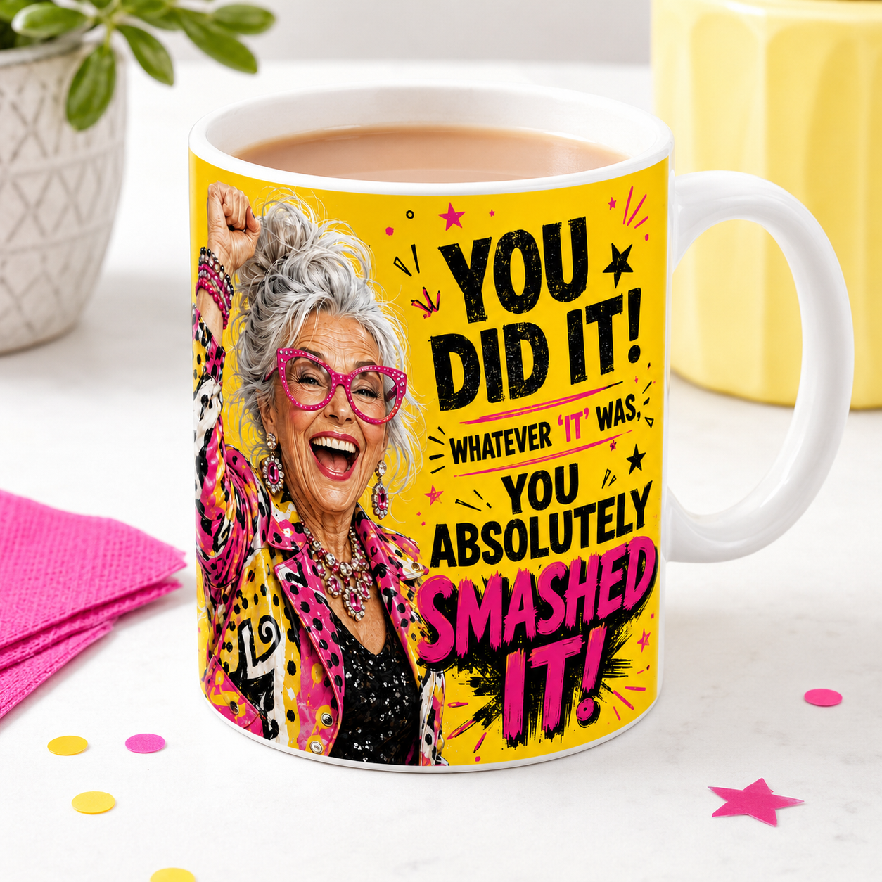 You Did It You Absolutely Smashed It celebration mug filled with tea or coffee, featuring a jubilant silver-haired woman with colourful clothing and pink glasses.