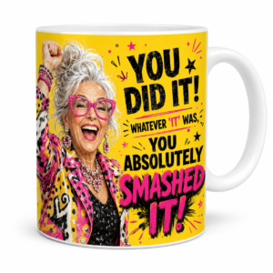 You Did It You Absolutely Smashed It 11oz celebration mug featuring a jubilant silver-haired older woman in pink glasses and colourful clothing.